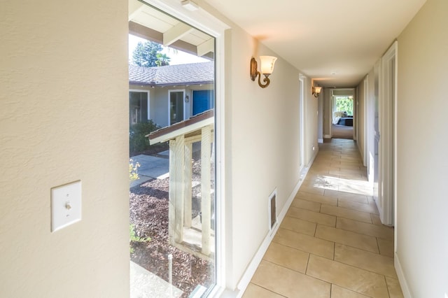2805 W Spruce Ave, Fresno, CA 93711 - hallway with light tile patterned floors and baseboards
