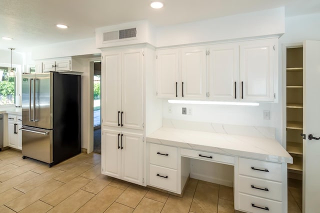 2805 W Spruce Ave, Fresno, CA 93711 - kitchen with stainless steel appliances, built in study area, white cabinets, plenty of natural light, and recessed lighting