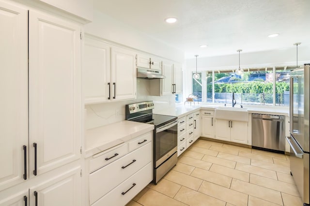 2805 W Spruce Ave, Fresno, CA 93711 - kitchen with appliances with stainless steel finishes, under cabinet range hood, light countertops, white cabinets, and recessed lighting