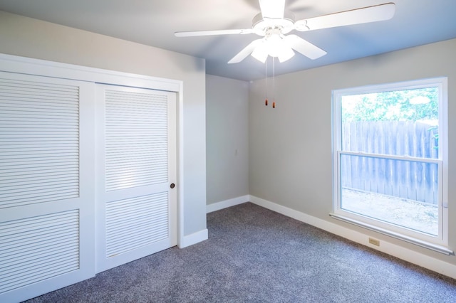 2805 W Spruce Ave, Fresno, CA 93711 - unfurnished bedroom with dark carpet, a closet, and ceiling fan