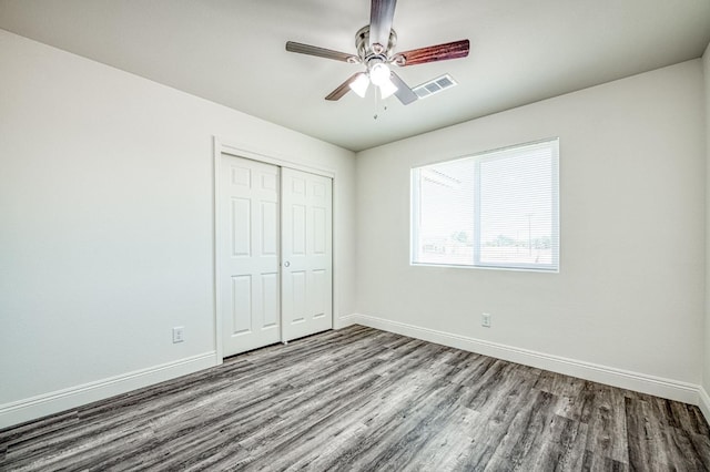 19930 Olympia Rd, Madera, CA 93638 - unfurnished bedroom featuring wood finished floors, a closet, and ceiling fan
