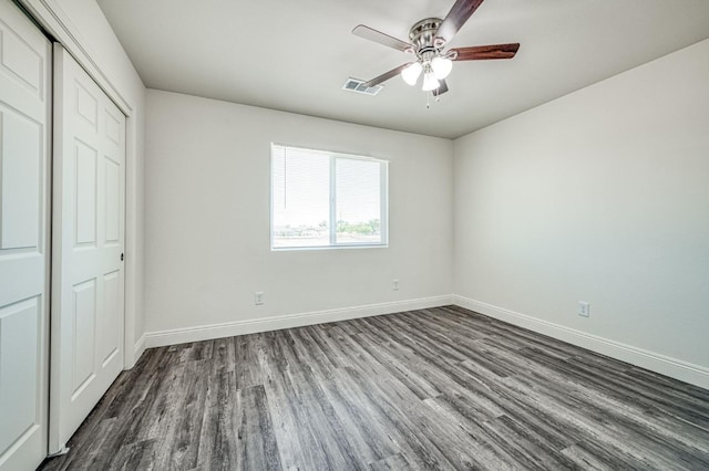 19930 Olympia Rd, Madera, CA 93638 - unfurnished bedroom with dark wood-style flooring, a closet, and ceiling fan