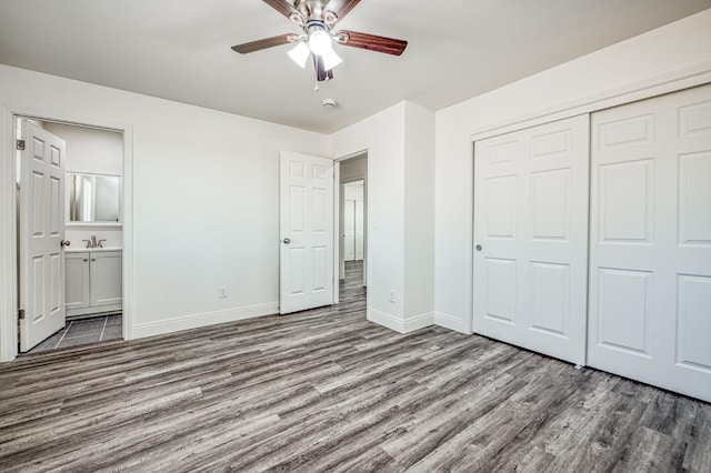 19930 Olympia Rd, Madera, CA 93638 - unfurnished bedroom with wood finished floors, a closet, ensuite bath, and ceiling fan