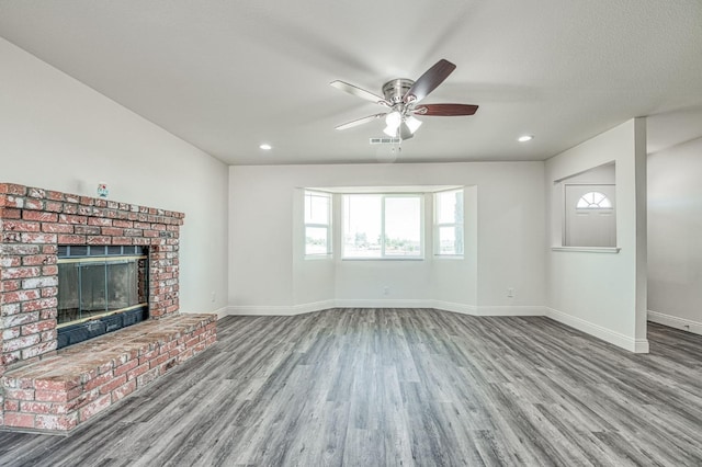 19930 Olympia Rd, Madera, CA 93638 - unfurnished living room with wood finished floors, a ceiling fan, a brick fireplace, and recessed lighting
