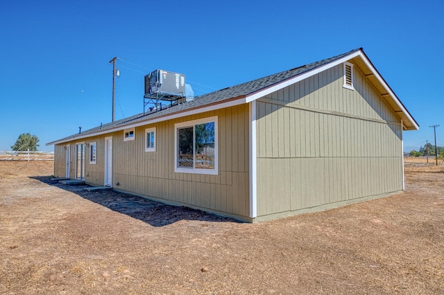 19930 Olympia Rd, Madera, CA 93638 - view of side of home with a central AC unit and roof with shingles