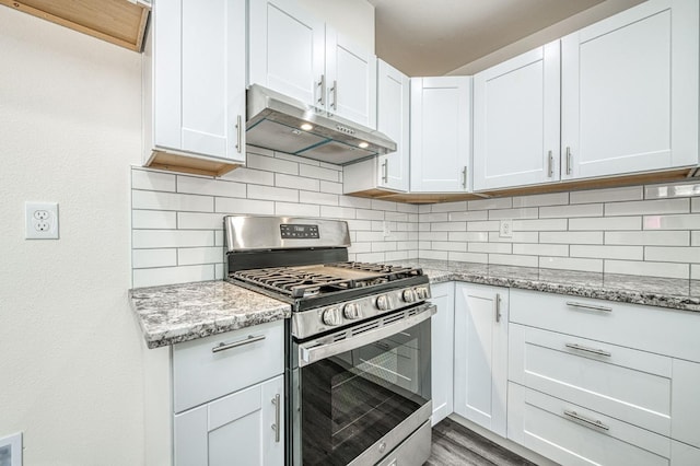 19930 Olympia Rd, Madera, CA 93638 - kitchen with stainless steel range with gas cooktop, under cabinet range hood, decorative backsplash, and light stone countertops