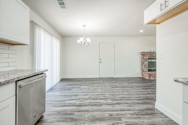 19930 Olympia Rd, Madera, CA 93638 - unfurnished dining area featuring a chandelier, light wood-type flooring, a fireplace, and recessed lighting
