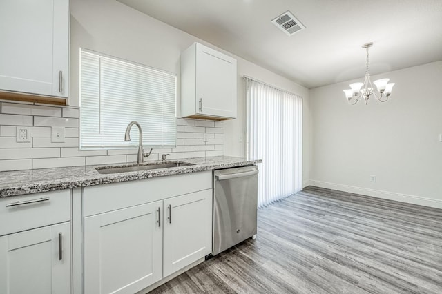 19930 Olympia Rd, Madera, CA 93638 - kitchen featuring stainless steel dishwasher, light wood-type flooring, backsplash, white cabinets, and light stone counters