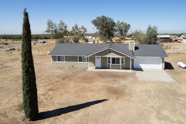 19930 Olympia Rd, Madera, CA 93638 - ranch-style house featuring an attached garage, dirt driveway, and a chimney