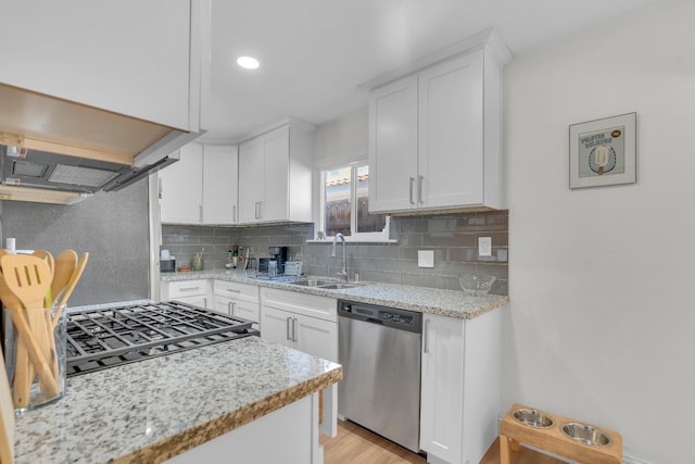 1383 N Safford Ave, Fresno, CA 93728 - kitchen featuring stainless steel dishwasher, decorative backsplash, white cabinetry, ventilation hood, and light stone counters