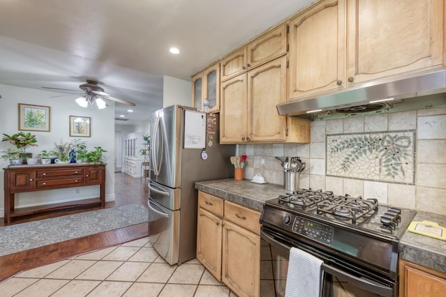 10311 E San Jose Ave, Clovis, CA 93619 - kitchen with black gas range oven, under cabinet range hood, dark countertops, a ceiling fan, and backsplash