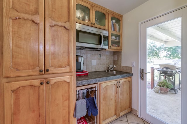 10311 E San Jose Ave, Clovis, CA 93619 - kitchen with stainless steel microwave, backsplash, dark countertops, and glass insert cabinets