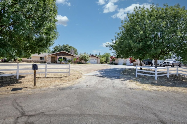 10311 E San Jose Ave, Clovis, CA 93619 - view of front of house with a fenced front yard, a chimney, a garage, and driveway