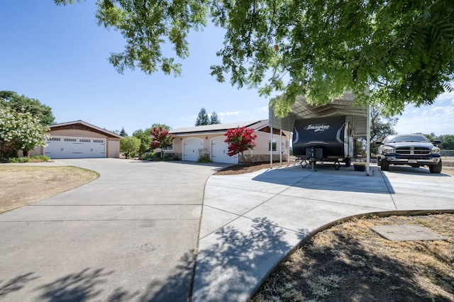 10311 E San Jose Ave, Clovis, CA 93619 - view of front of house featuring concrete driveway, a carport, and a garage