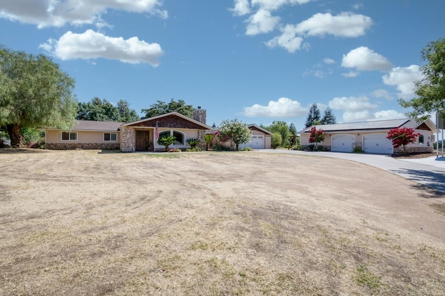 10311 E San Jose Ave, Clovis, CA 93619 - view of front facade featuring a garage and a chimney