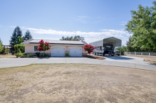 10311 E San Jose Ave, Clovis, CA 93619 - view of front facade with driveway, roof mounted solar panels, and a detached carport