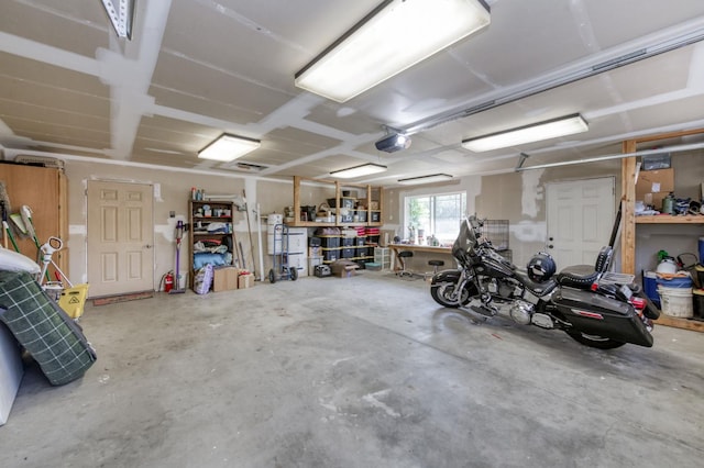 10311 E San Jose Ave, Clovis, CA 93619 - garage featuring a garage door opener and a workshop area