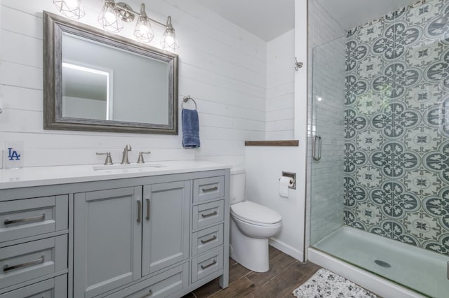 10311 E San Jose Ave, Clovis, CA 93619 - bathroom with vanity, wood finished floors, a stall shower, and wooden walls