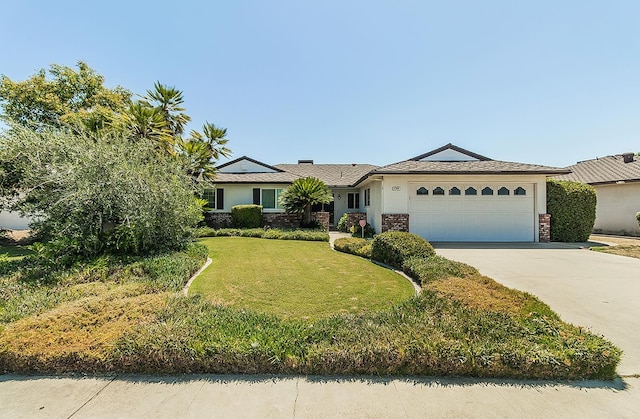 4368 N Hughes Ave, Fresno, CA 93705 - ranch-style home with an attached garage, driveway, a front yard, and stucco siding
