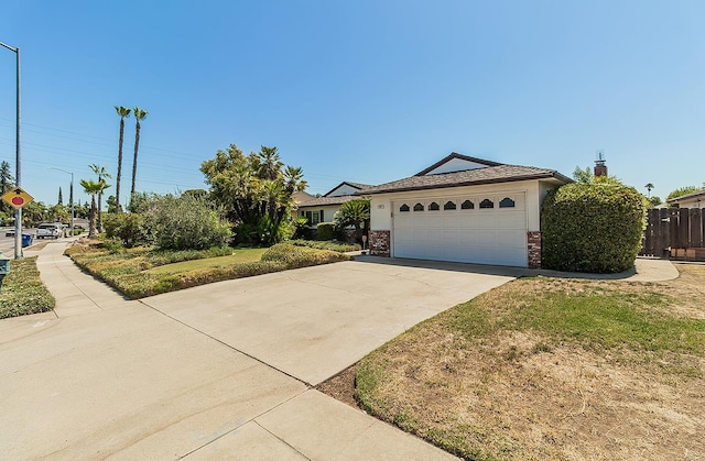 4368 N Hughes Ave, Fresno, CA 93705 - ranch-style home with driveway, brick siding, and a garage