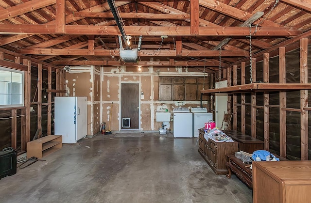 4368 N Hughes Ave, Fresno, CA 93705 - garage with washing machine and clothes dryer, freestanding refrigerator, and a garage door opener