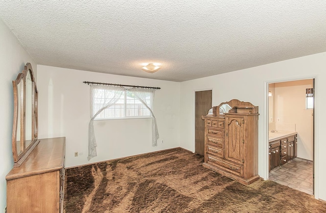 4368 N Hughes Ave, Fresno, CA 93705 - carpeted bedroom with a textured ceiling and connected bathroom