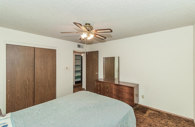 4368 N Hughes Ave, Fresno, CA 93705 - bedroom with dark carpet, a closet, ceiling fan, and a textured ceiling