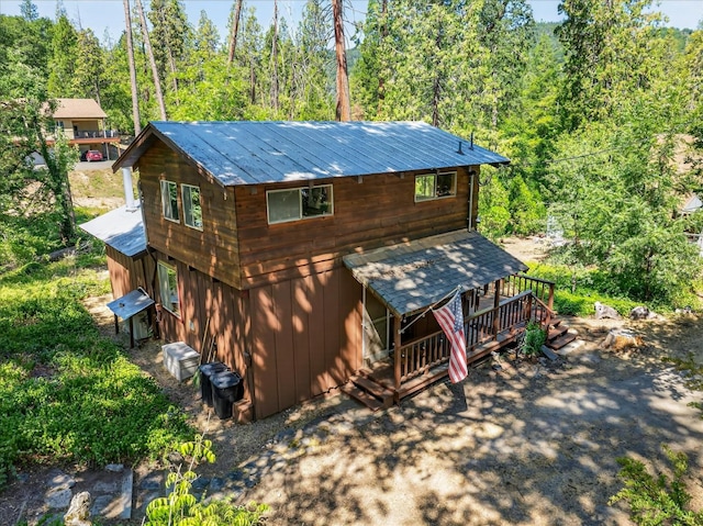 44800 Mountain Meadow Rd, Oakhurst, CA 93644 - view of front facade featuring a wooded view and a wooden deck