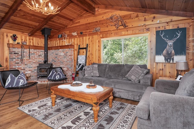 44800 Mountain Meadow Rd, Oakhurst, CA 93644 - living area featuring wood finished floors, wood walls, a wood stove, wood ceiling, and a chandelier
