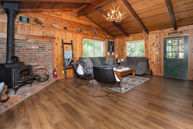 44800 Mountain Meadow Rd, Oakhurst, CA 93644 - living room with wood ceiling, a wood stove, wood finished floors, a chandelier, and wooden walls