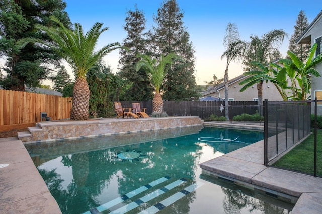 632 W Palo Alto Ave, Clovis, CA 93612 - pool at dusk featuring a fenced backyard