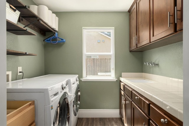 632 W Palo Alto Ave, Clovis, CA 93612 - washroom with washer and dryer, dark wood finished floors, and cabinet space