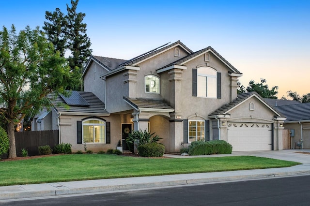 632 W Palo Alto Ave, Clovis, CA 93612 - traditional home featuring stucco siding, solar panels, driveway, a garage, and a tile roof