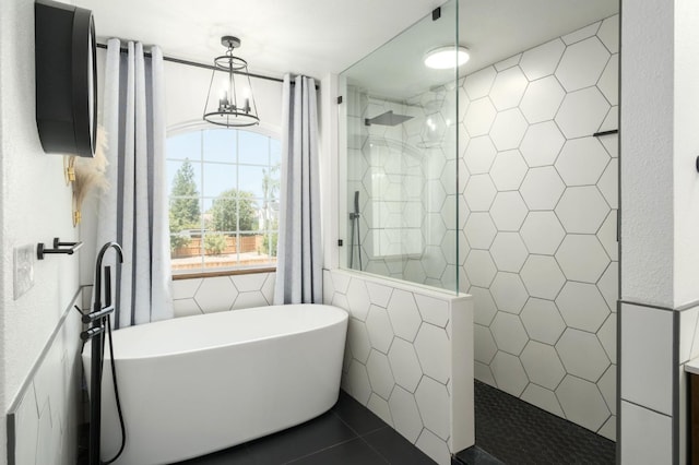632 W Palo Alto Ave, Clovis, CA 93612 - bathroom featuring tile walls, a freestanding tub, walk in shower, and tile patterned flooring