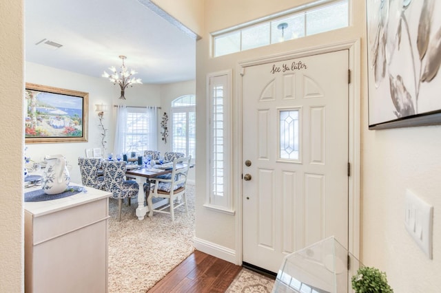 212 W Everglade Ave, Clovis, CA 93619 - foyer entrance with dark wood-style floors and a chandelier