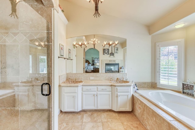 212 W Everglade Ave, Clovis, CA 93619 - bathroom with a bath, vanity, a stall shower, ensuite bathroom, and a chandelier