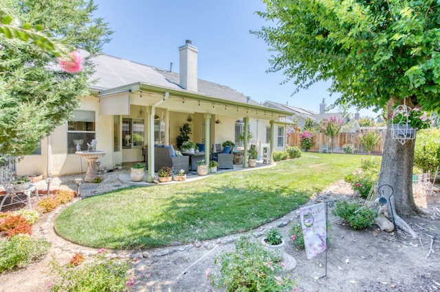 212 W Everglade Ave, Clovis, CA 93619 - back of property with an outdoor living space, a chimney, a patio area, and stucco siding