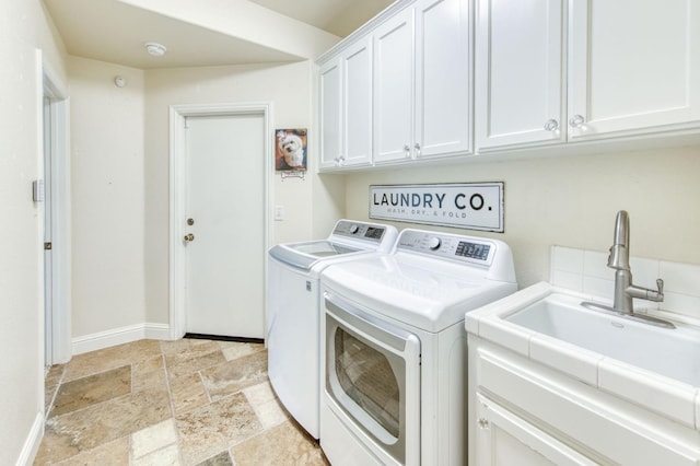 212 W Everglade Ave, Clovis, CA 93619 - laundry room featuring independent washer and dryer, stone tile flooring, and cabinet space