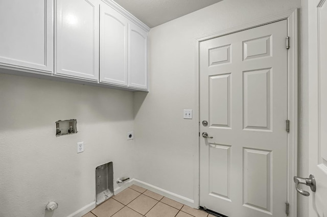 840 Morris Ln, Madera, CA 93637 - laundry room with cabinet space, electric dryer hookup, light tile patterned flooring, washer hookup, and gas dryer hookup