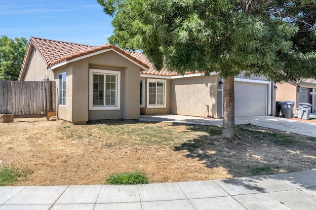 840 Morris Ln, Madera, CA 93637 - view of front of home featuring stucco siding, concrete driveway, a tile roof, and an attached garage