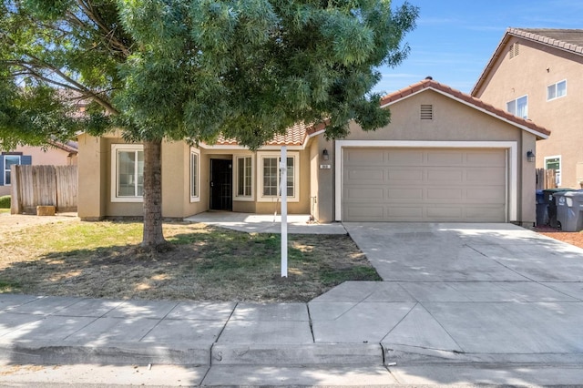 840 Morris Ln, Madera, CA 93637 - view of front of house featuring a tiled roof, stucco siding, an attached garage, and driveway