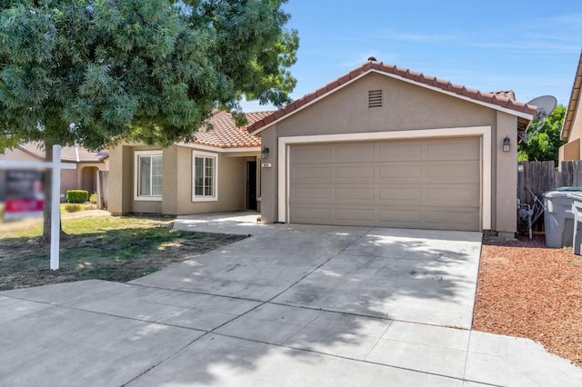 840 Morris Ln, Madera, CA 93637 - view of front facade with driveway, a tiled roof, stucco siding, and an attached garage