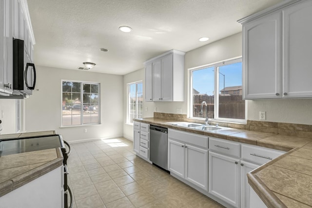 840 Morris Ln, Madera, CA 93637 - kitchen with black appliances, white cabinets, a textured ceiling, light tile patterned floors, and recessed lighting