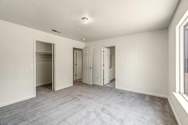 840 Morris Ln, Madera, CA 93637 - unfurnished bedroom featuring carpet, a walk in closet, multiple windows, and a closet