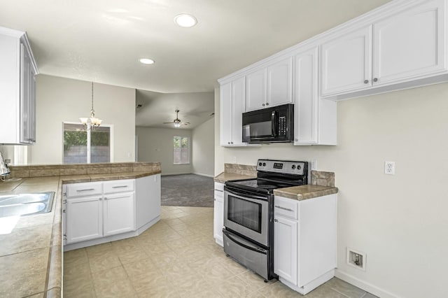 840 Morris Ln, Madera, CA 93637 - kitchen with black microwave, electric stove, white cabinets, a peninsula, and ceiling fan