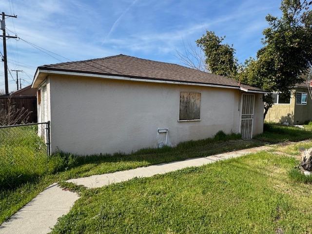 3922 E Lyell Ave, Fresno, CA 93702 - view of property exterior with stucco siding and a shingled roof