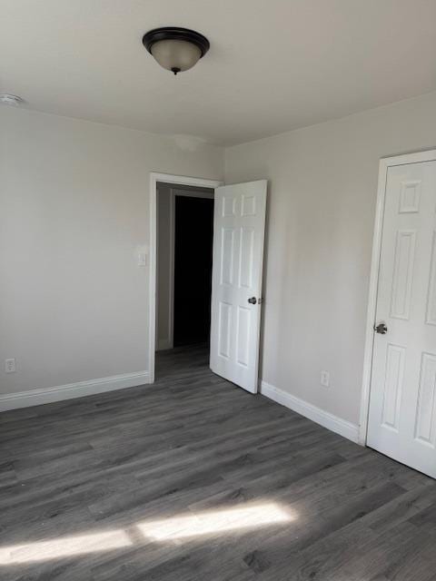3922 E Lyell Ave, Fresno, CA 93702 - spare room with dark wood-style flooring and a smoke detector