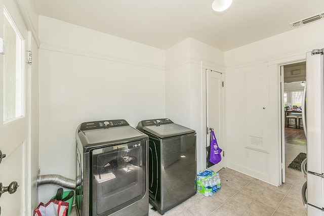 4430 E Iowa Ave, Fresno, CA 93702 - washroom featuring washer and clothes dryer and light tile patterned floors