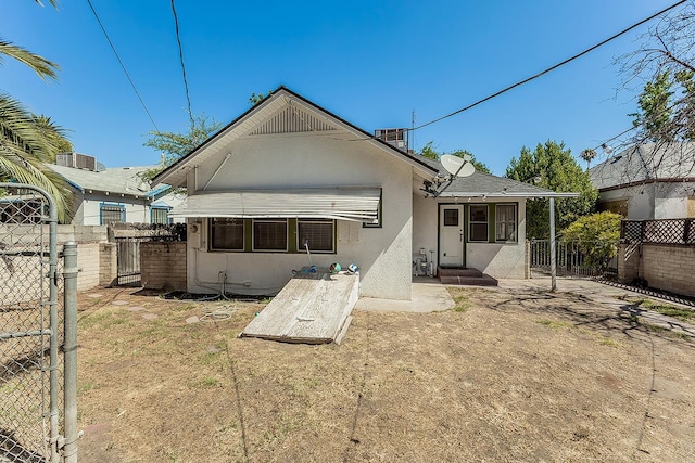 4430 E Iowa Ave, Fresno, CA 93702 - rear view of property with stucco siding and a gate