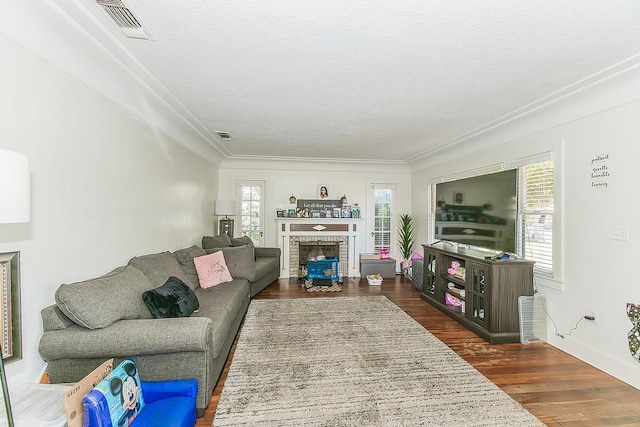 4430 E Iowa Ave, Fresno, CA 93702 - living room with wood finished floors, a brick fireplace, a textured ceiling, and crown molding